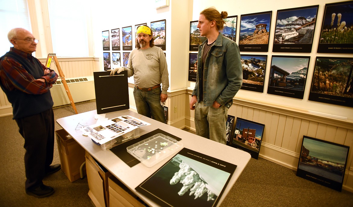 From left, Terry Abell, Bret Bouda and Jacob Thomas, the executive director of the Museum at Central School, discuss the James Bakke exhibit. The photography show will open on Wednesday, Oct. 11, with a reception from 5 to 7 p.m. (Brenda Ahearn/Daily Inter Lake)