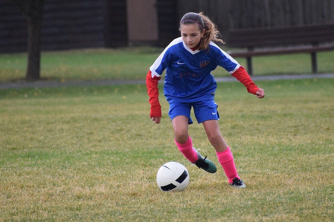 Courtesy photo
Olivia Azzollini of the North Idaho Inferno girls &#145;04 Hartzell maneuvers with the ball during a game against the Sandpoint Strikers FC Giese. In recognition of Breast Cancer Awareness month the Inferno teams will wear pink socks in dedication to our Inferno and community families who have been affected by this illness.