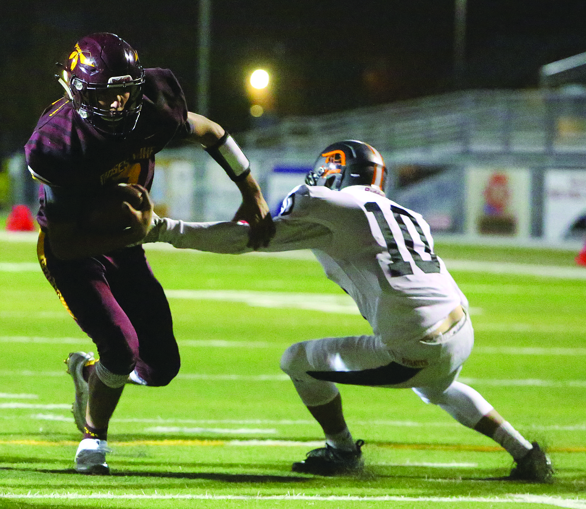 Connor Vanderweyst/Columbia Basin Herald
Moses Lake quarterback Dominic Signorelli dodges a Davis tackler for a touchdown in the second quarter.