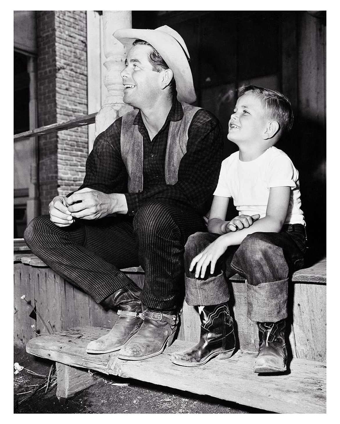 Peter Ford, right, visiting his father Glenn Ford on the set of The Redhead and the Cowboy, a 1950 film featuring Glenn Ford and Rhonda Fleming. (Photo courtesy of Peter Ford)