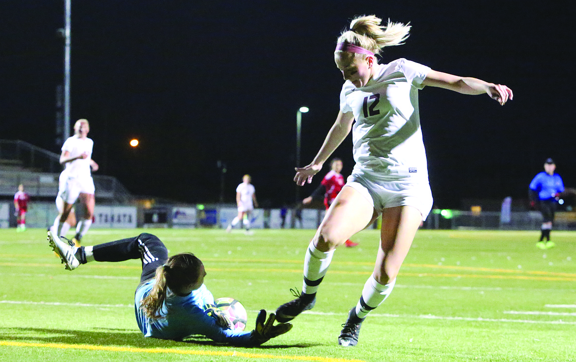 Connor Vanderweyst/Columbia Basin Herald
Moses Lake's Morgan Skone has a shot saved and is tripped up by Sunnyside goalie Morgan Duim.