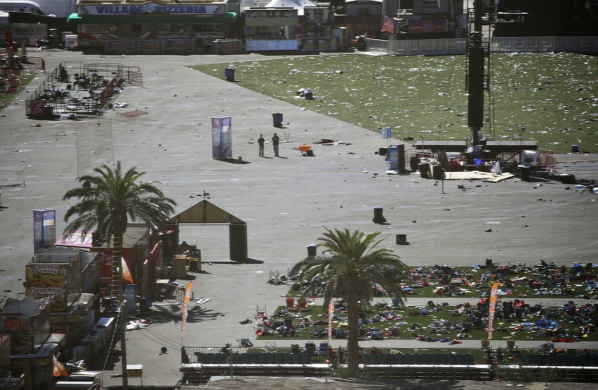 EDS NOTE: GRAPHIC CONTENT - Debris is strewn through the scene of a mass shooting at a music festival near the Mandalay Bay resort and casino on the Las Vegas Strip, Monday, Oct. 2, 2017, in Las Vegas. (AP Photo/John Locher)