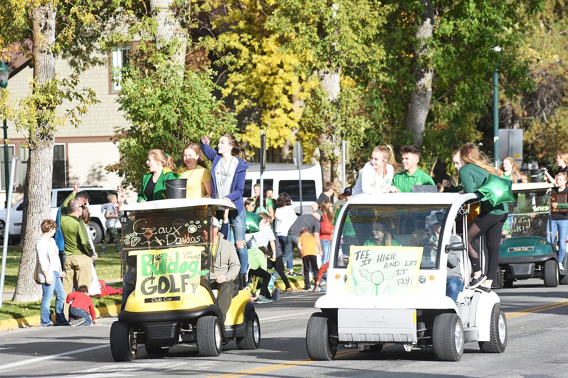 Whitefish golfers cruise down Second Street in their golf carts during the homecoming parade on Friday. (Daniel McKay/Whitefish Pilot)