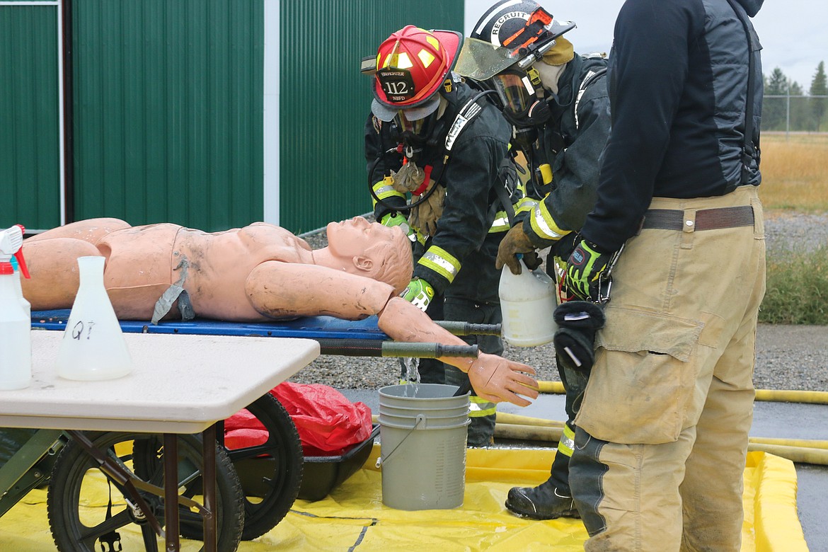 Photo by Mandi Bateman
Firefighters decontaminate the first &#147;victim&#148; of the training exercise.