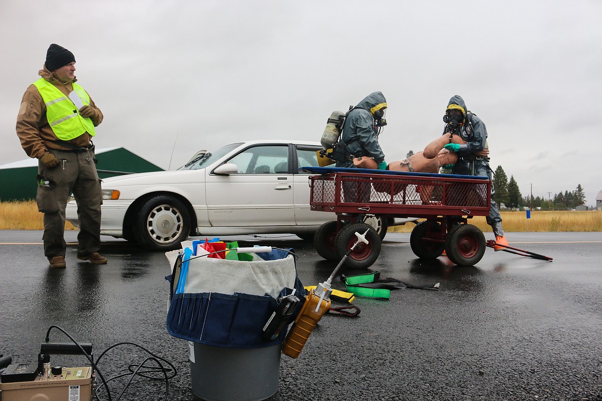 Photo by Mandi Bateman
Hazmat crews remove the body of the simulated crash victim.