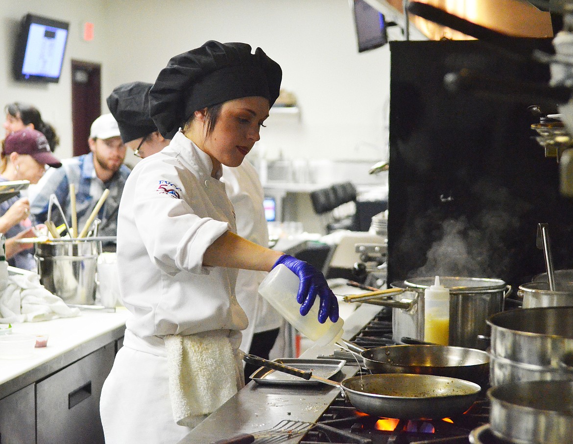 Culinary student Savannah Fraleigh cooks during the soft opening of the Eclipse restaurant at the instructional kitchen at Flathead Valley Community College. (Heidi Desch/Whitefish Pilot)