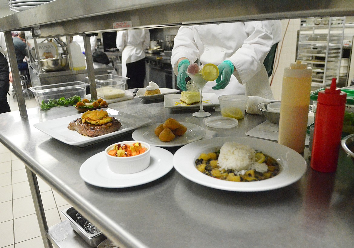 A variety of dishes are ready to be taken to tables during the Eclipse restaurant night at Flathead Valley Community College.