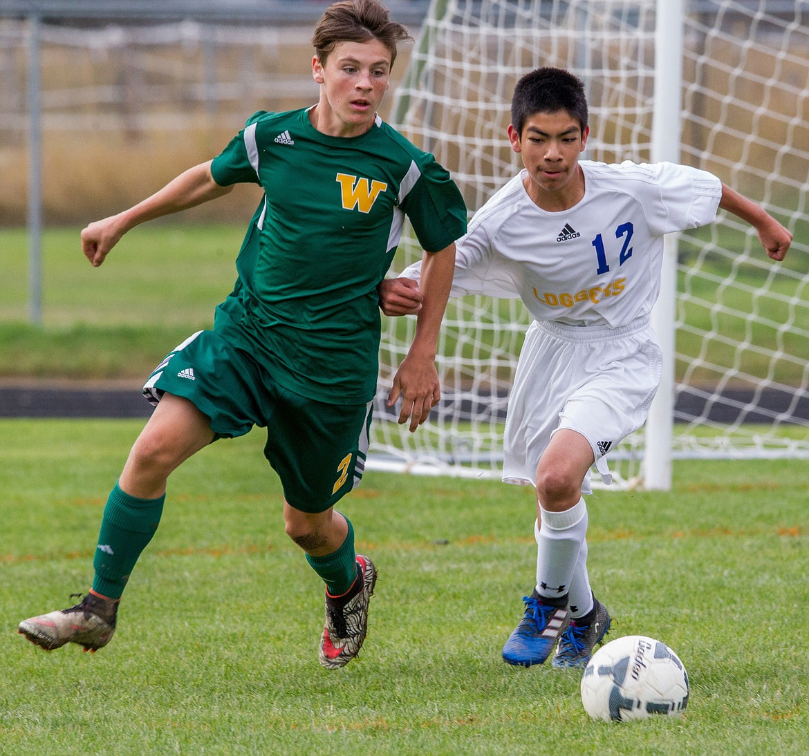 Libby's ??? ???, right, and Carson White of Whitefish battle for the ball Saturday in Libby. (John Blodgett/The Western News)