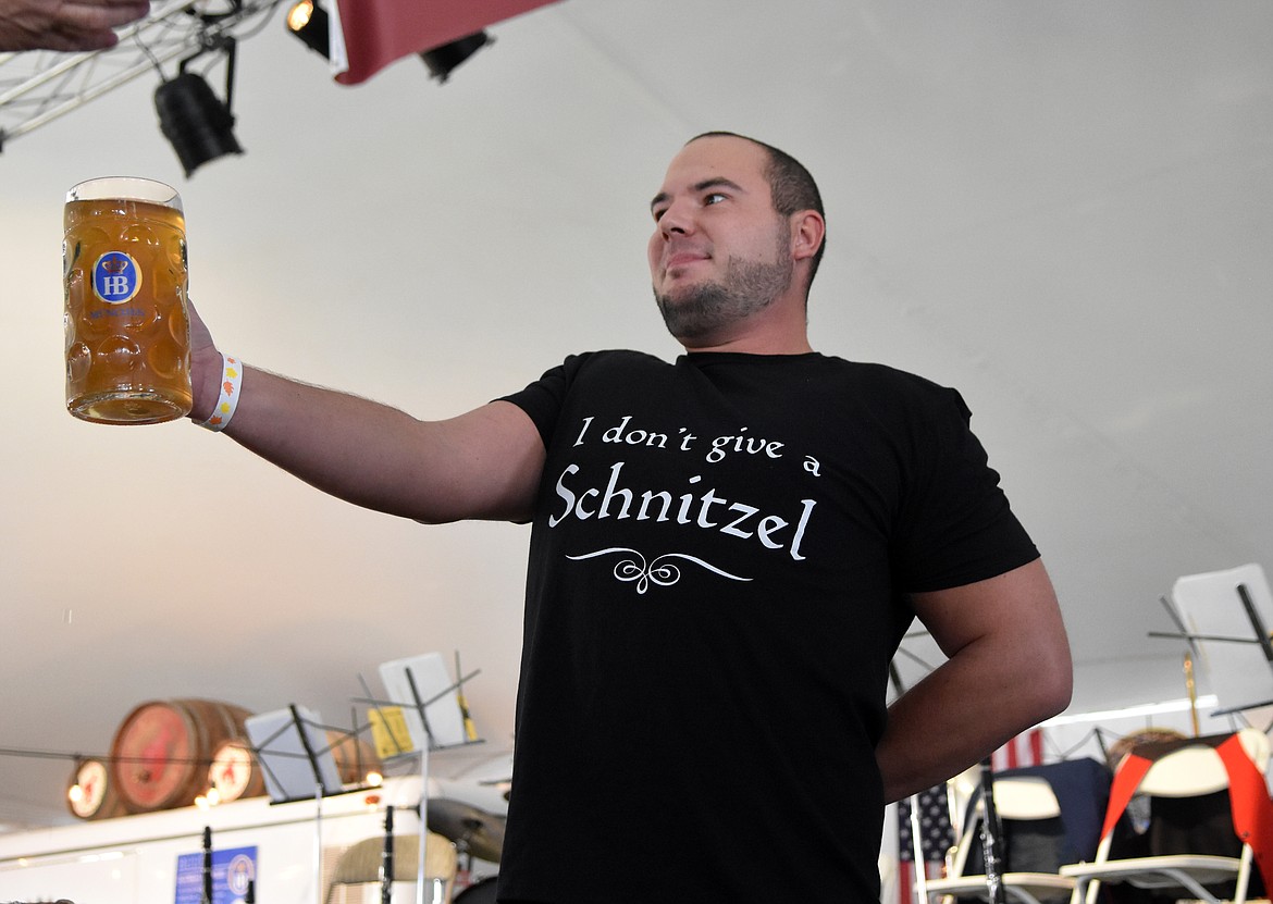 Ryley Yocom, of Kalispell, competes in the men&#146;s stein-holding contest Saturday during the Great Northwest Oktoberfest in Depot Park. (Heidi Desch/Whitefish Pilot)