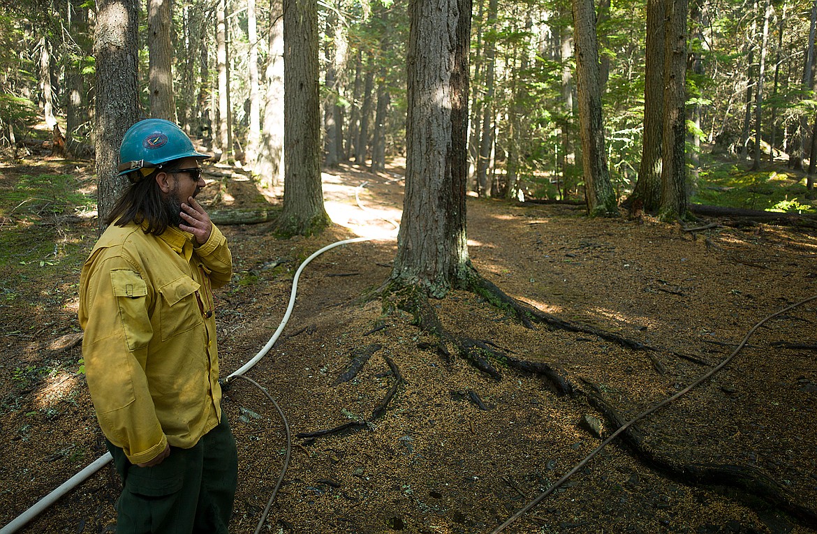 Safety officer and Flathead Hot Shot Shawn Borgen looks out at a sprinkler system set up on the John&#146;s Lake Trail.