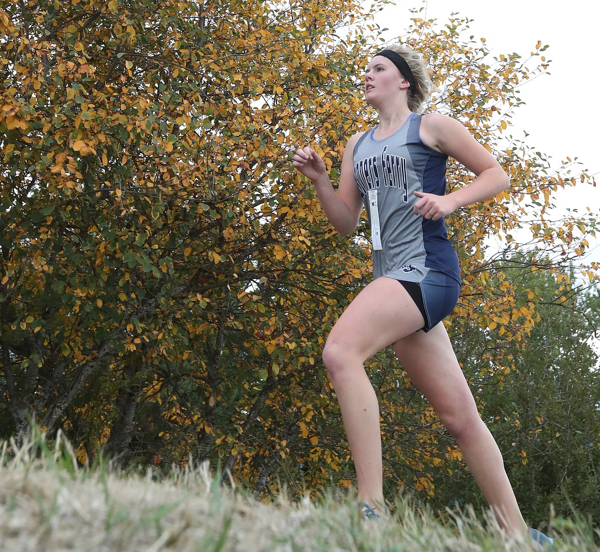 Lauren Stidham, shown on the course and sprinting to the finish line, achieved a personal best at Travers Park on Saturday, Sept. 30.