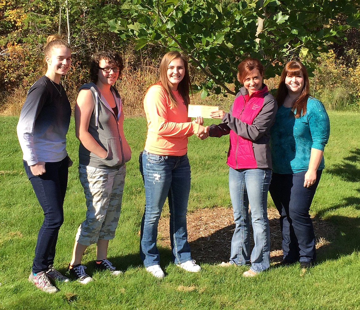 The Troy High School chapter of the National Honor Society recently donated $1000 to help victims of recent natural disasters. They gave $500 to the Salvation Army for its work with Hurricane Harvey victims and $500 to local fundraising efforts for the eleven families who lost their homes to the Caribou Creek fire. Pictured from left to right are: Sarah Osborn, secretary/treasurer; Desirae Bowers, vice-president; Kaitlyn Downey, president; Summer McDonald, portfolio assistant at First Montana Bank, Libby; and Angie Huisentruit, branch retail manager at First Montana Bank, Troy. (Courtesy photo)