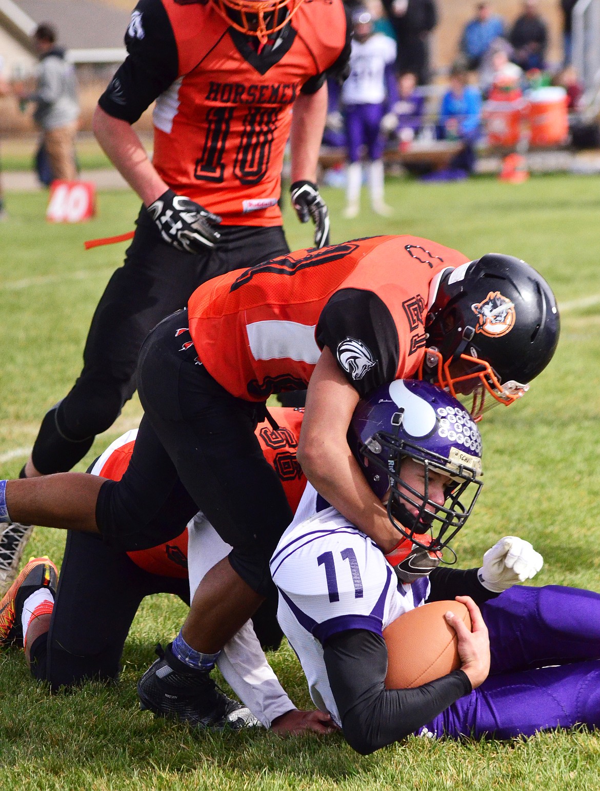 The Horesemen teamed up to get a stop on Viking Garett Vaughan(11) from running the ball. (Erin Jusseaume/ Clark Fork Valley Press)