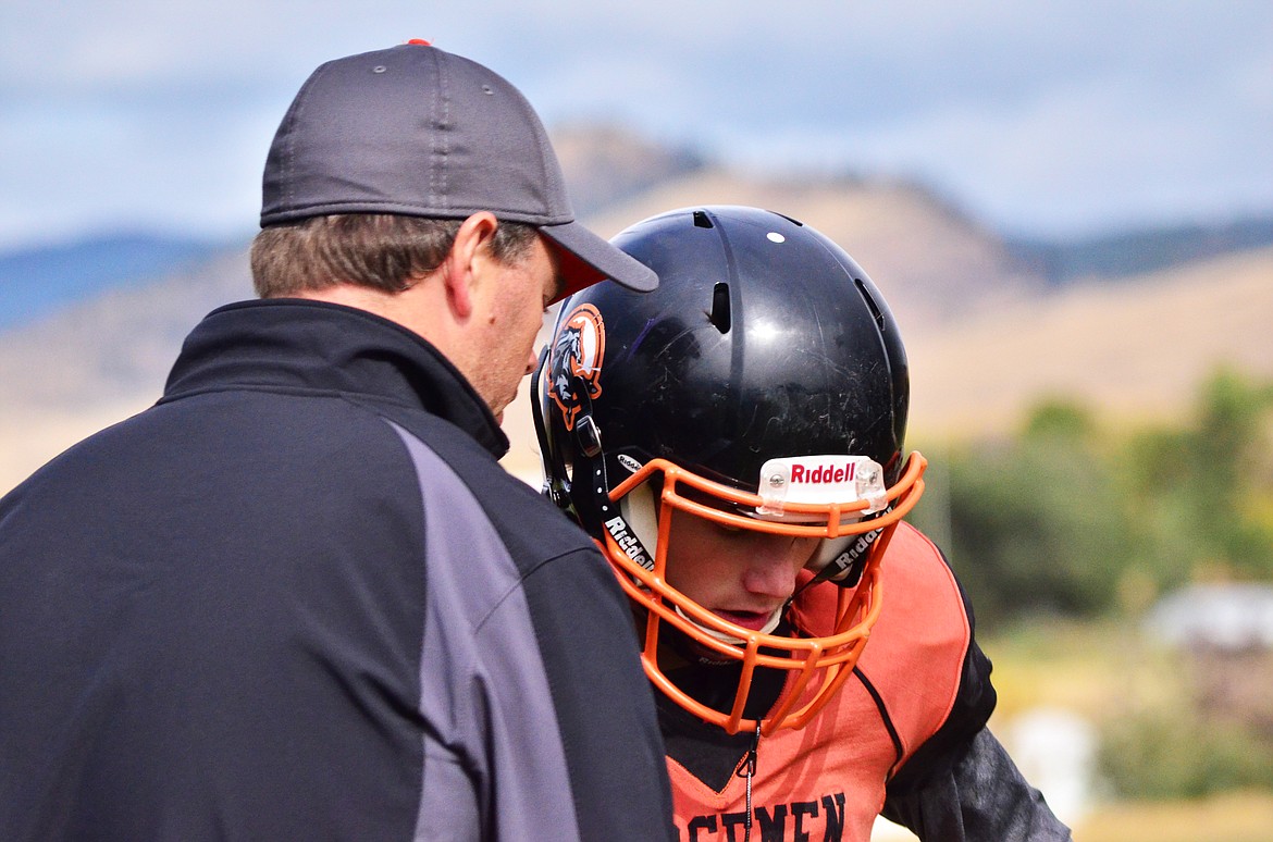 Horsemen Coach Eddie Fultz gets the boys set up for a positive play to gain yards towards the home side endzone. (Erin Jusseaume/ Clark Fork Valley Press)