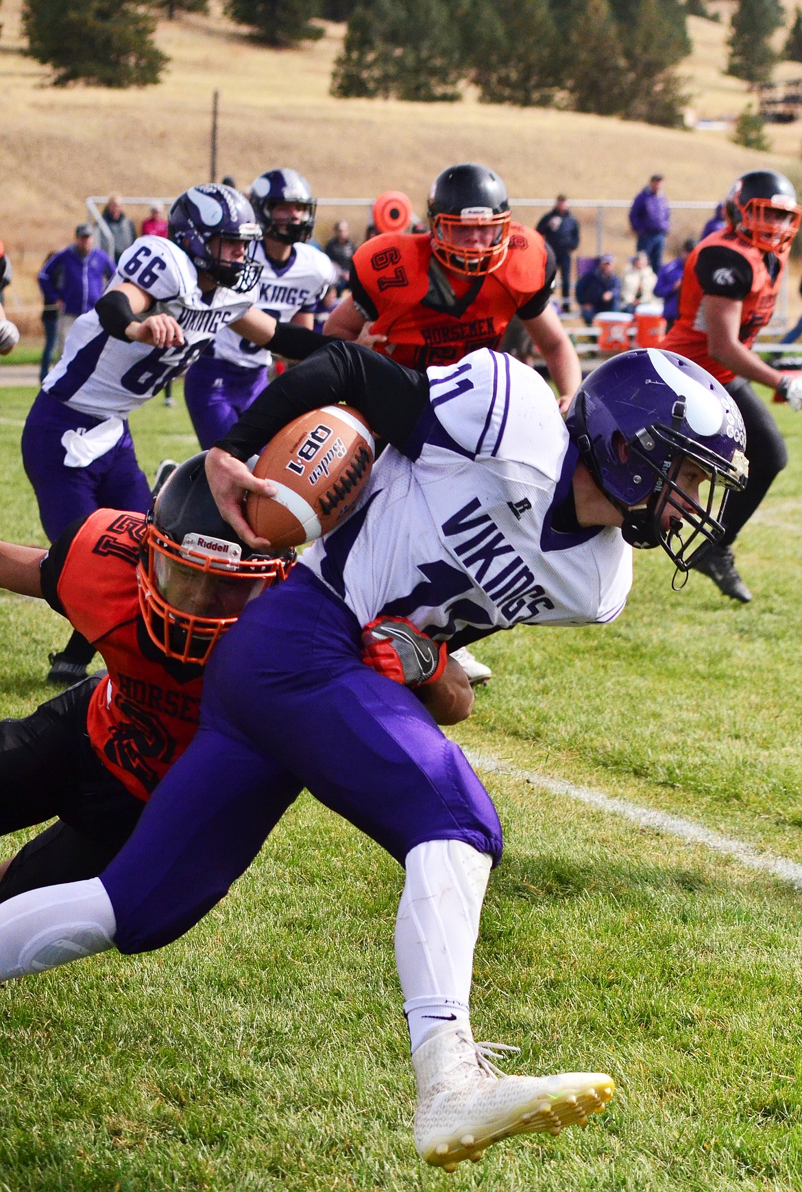 Orion Pry-Hyde(21) goes low and hard to stop Viking Garett Vaughan(11) from gaining yards. (Erin Jusseaume/ Clark Fork Valley Press)