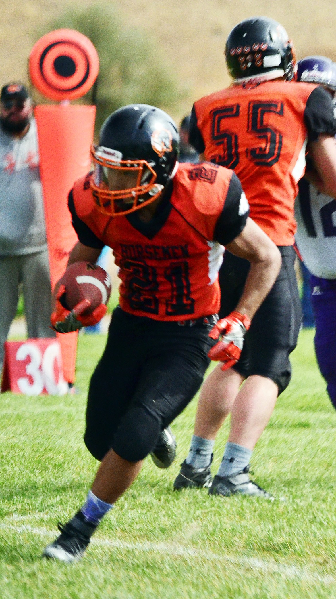 Orion Pry-Hyde(21) gains yards before tackled. (Erin Jusseaume/ Clark Fork Valley Press)