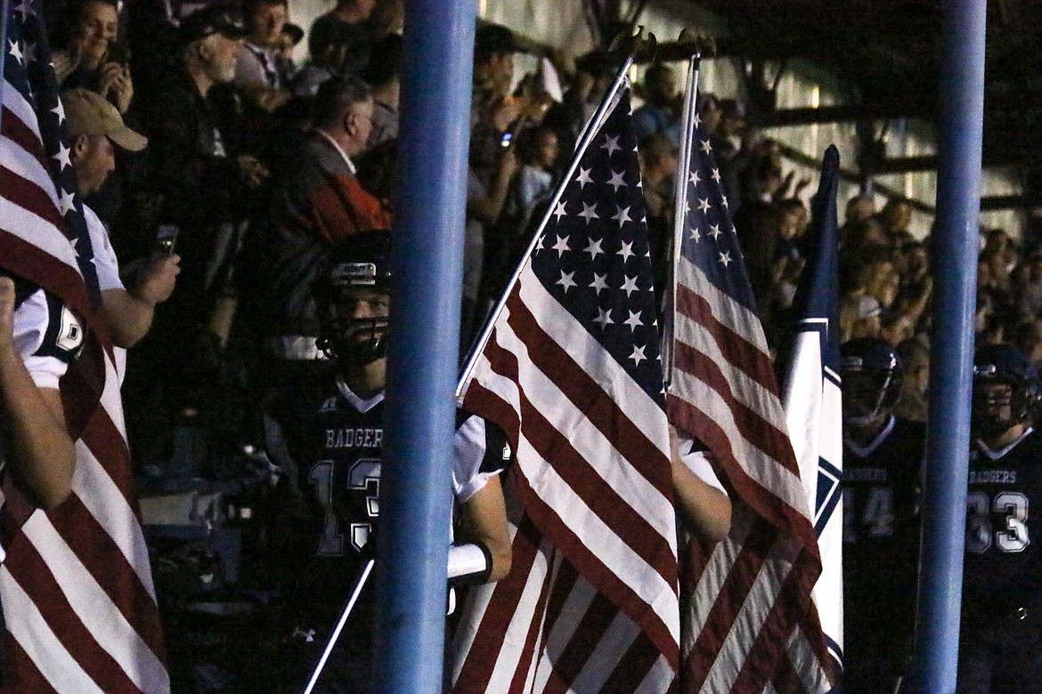 Photo by Mandi Bateman
The Bonners Ferry High School Football team entered through the stands, carrying American Flags, to the enthusiastic cheering of the crowd.