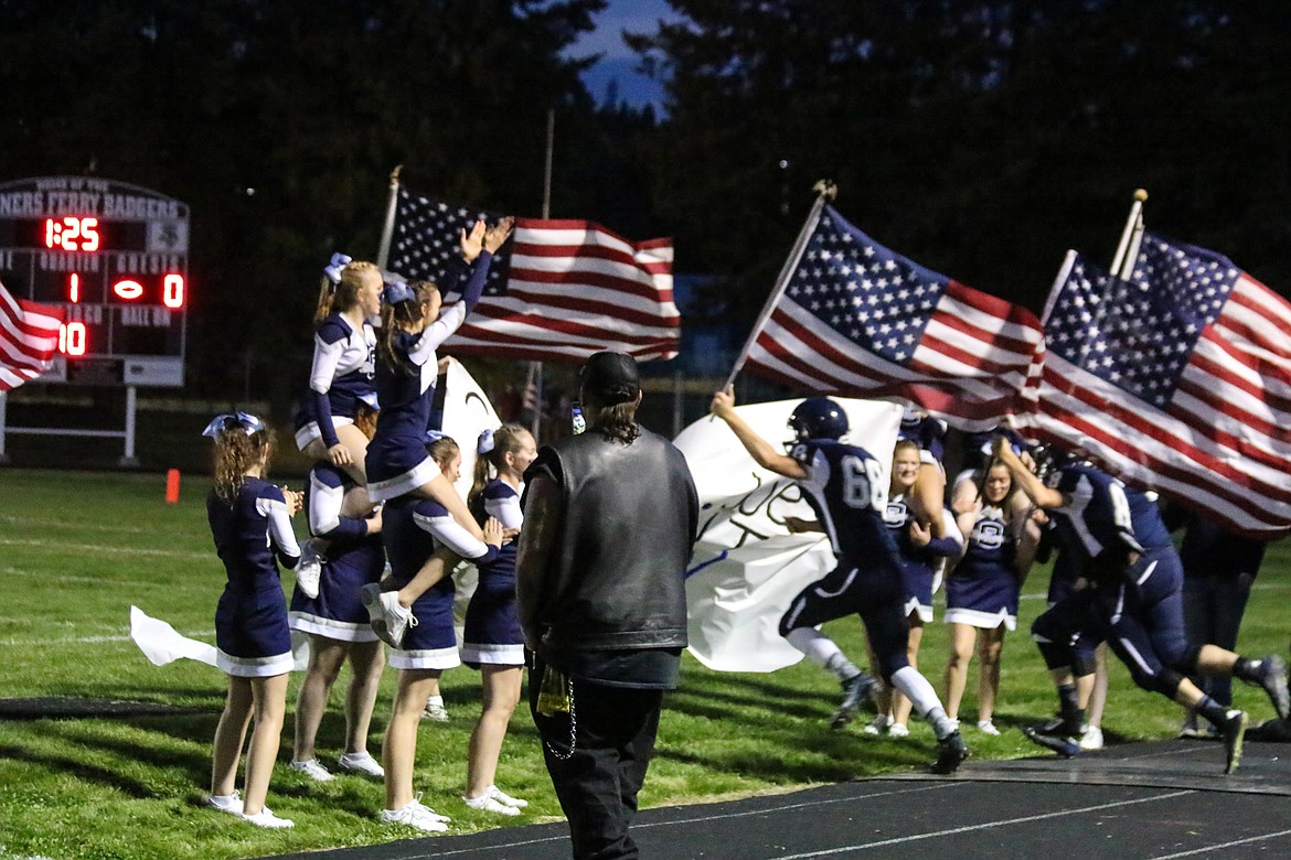 Photo by Mandi Bateman
Showing both spirit and national pride, the football players enter the field in style.