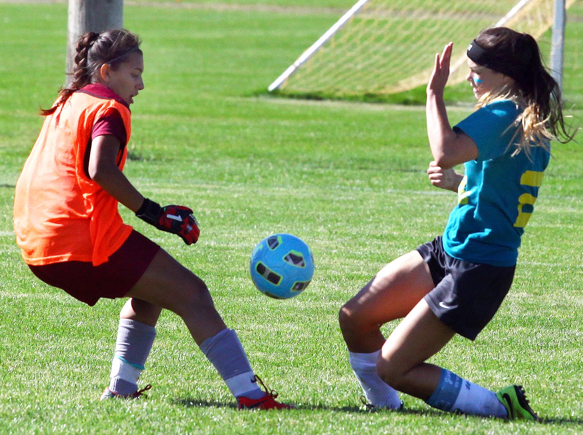 Rodney Harwood/Columbia Basin HeraldEphrata striker Mya Spencer (2) chases a ball into the box as Grandview goalkeeper Anabell Pallares comes out to challenge during Saturday's CWAC game.