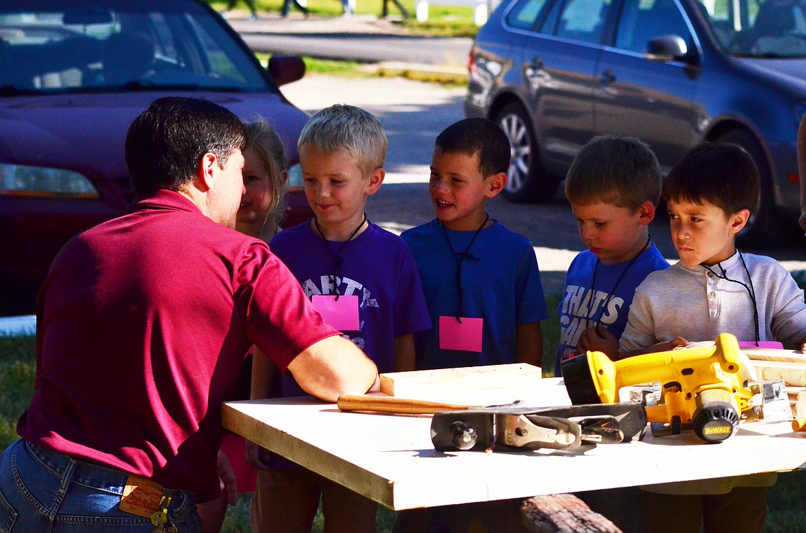 Mr. Chisholm had just as much fun as the kids on the contruction table talking about all the tools that are used. (Erin Jusseaume/Clark Fork Valley Press)