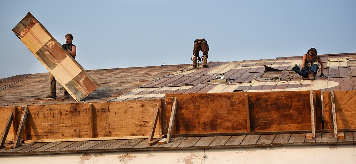 The crew from Heritage Timber LLC carefully deconstructs the roof of the Kalispell Lumber Company building.