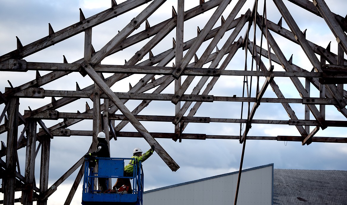 Crew members from Heritage Timber LLC work with Harmon Crane to dismantle and remove the Kalispell Lumber Company rafters on September 20.(Brenda Ahearn/Daily Inter Lake)