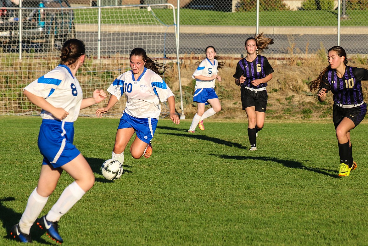 Above: Senior Jorryn Bennett dribbles the ball upfield against the Wildcats.