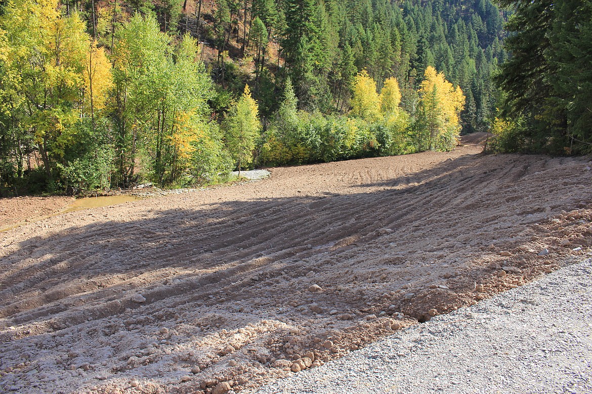 The ground between the road and Flat Creek is dug up and ready for reseeding as the final phase of the Flat Creek-Iron Mountain Mine superfund cleanup site comes to an end near Superior. (Kathleen Woodford/Mineral Independent).