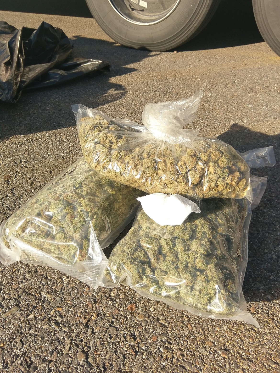 The seized cocaine can be seen atop of one of the larger marijuana busts.