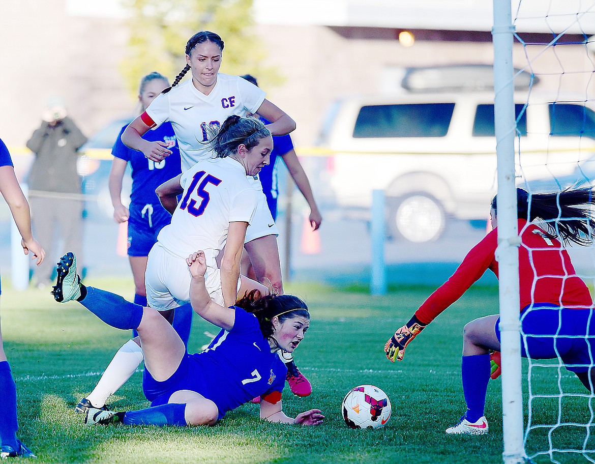 Josie Windauer (15) and Hannah Gedlaman look to knock a loose ball into the goal against Bigfork.