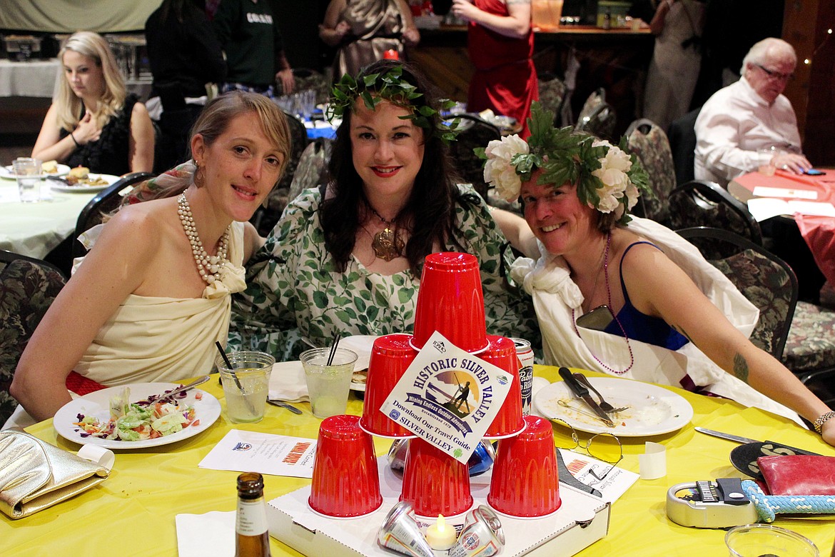 Denna Grangaard, SVC director Diannah Fields-Brown, and Becky Speck smile for the camera behind one of the tastefully crafted (and unique) centerpieces.