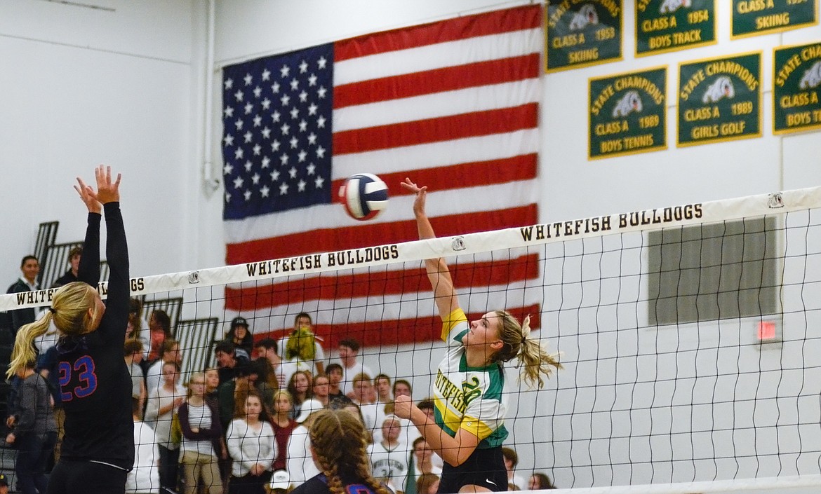 Cailyn Ross crushes the ball at the net against the Wildkats last week. (Daniel McKay/Whitefish Pilot)