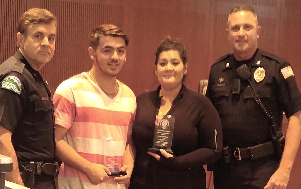 Photo courtesy of dity of Post Falls
Jacob Stuart and his mother, Michelle, received the Post Falls Police Department&#146;s Humanitarian Award for their involvement in locating a missing Post Falls girl who was involved in a human trafficking ring in the Seattle area this summer. On the left is Chief Scot Haug and right Assistant Chief Pat Knight.