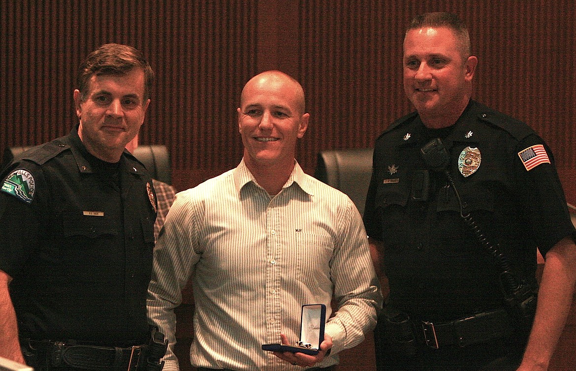 BRIAN WALKER/Press
Former Post Falls Police school-resource officer Try Roberg, center, received the department&#146;s Police Star Award for his role in finding a missing Post Falls girl who was involved in a human trafficking ring in the Seattle area this summer. On the left is Chief Scot Haug and right Assistant Chief Pat Knight.