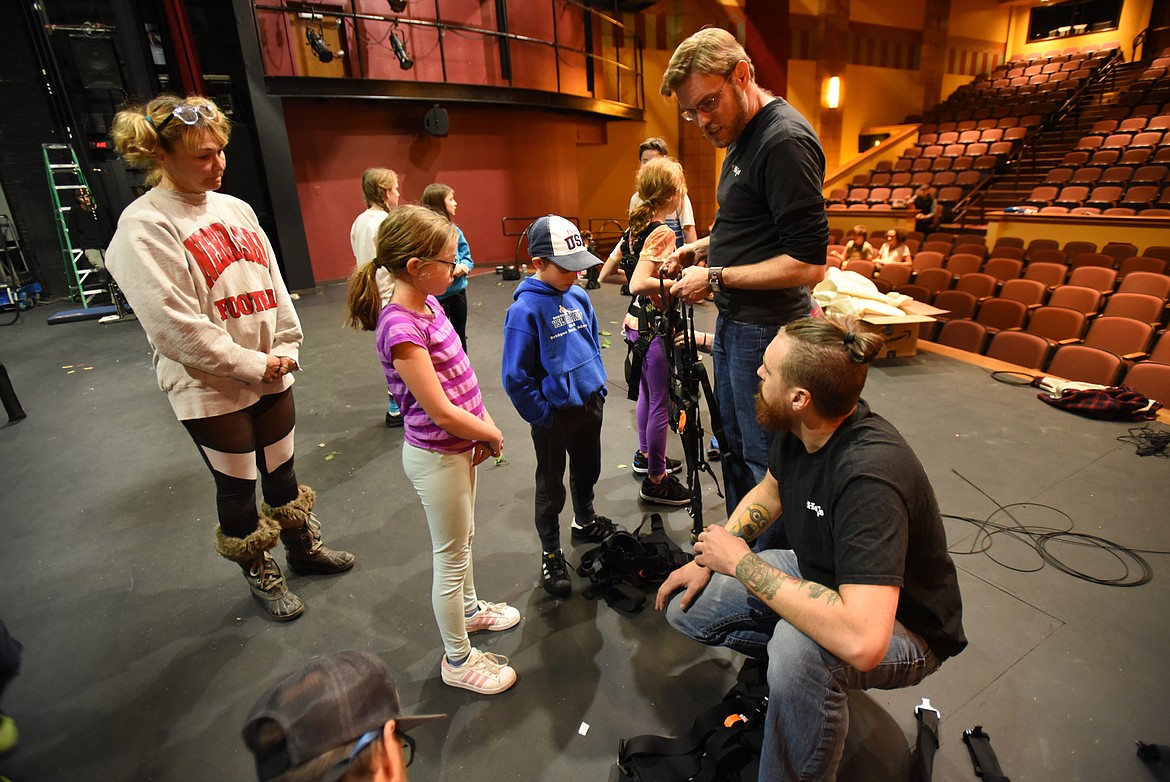 Shad Ramsey, standing, and Bryan Reilly, crouching, help cast members of the Alpine Theatre Project Kids production of “Tarzan the Musical” into harnesses for rehearsal. Ramsey and Reilly are the flying directors from ZFX Inc., the company hired to do the flying in the show.
(Brenda Ahearn/This Week in the Flathead)