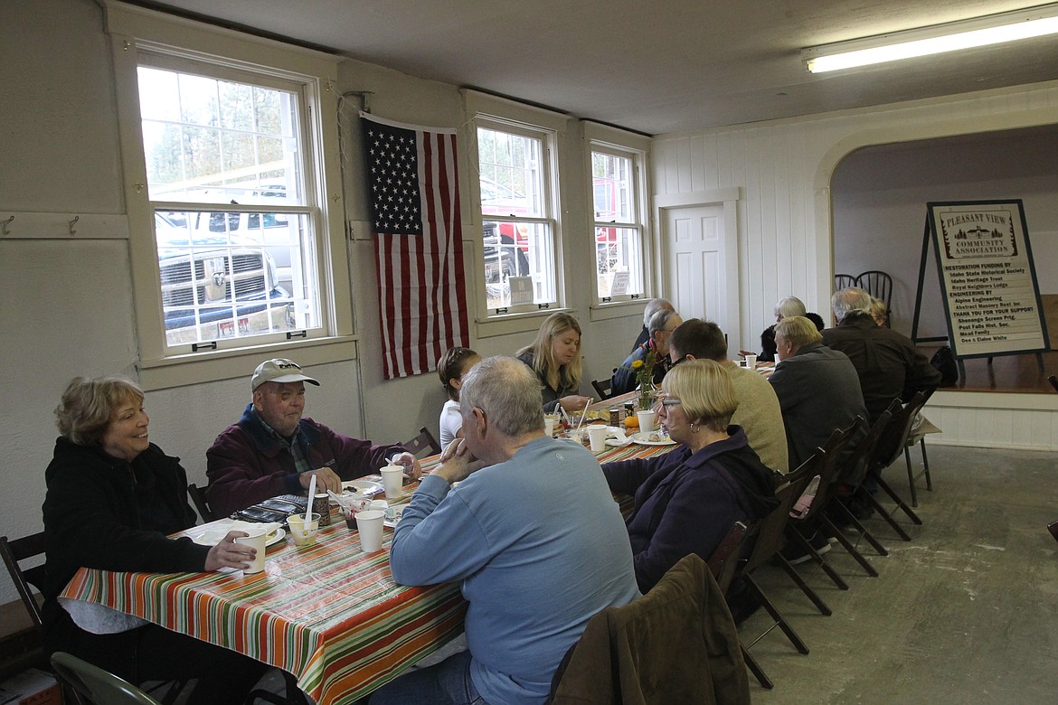 DEVIN HEILMAN/Press
Cowboy Breakfast attendees enjoy all-you-can-eat biscuits, gravy and eggs Saturday morning in the old Pleasantview School in Post Falls. About 125 people generally attend the breakfasts, which take place in the spring and fall. The breakfasts serve as fundraisers for the Pleasantview Community Association, the nonprofit that is working to restore the historic school.