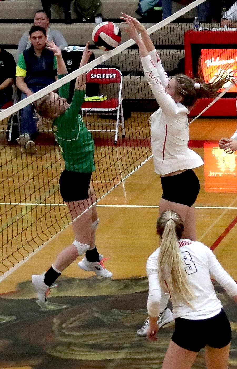 (Photo by ERIC PLUMMER)
Grace Kirscher, right, and Keely DeVore meet at the top of the net in the loser-out game of the district volleyball tournament.