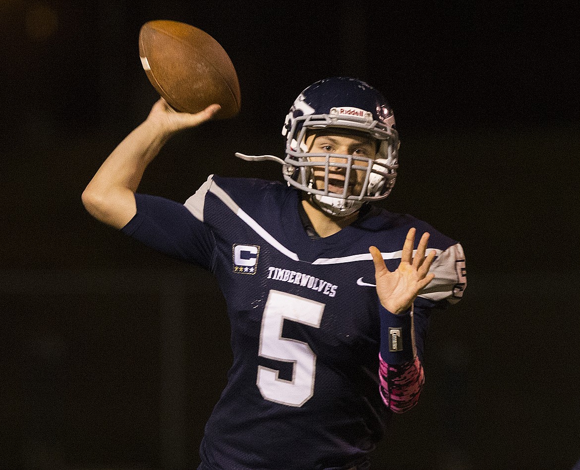 LOREN BENOIT/PressSenior Lake City quarterback Bryce Buttz passes the ball to a wide receiver during Friday night's game against Coeur d'Alene.