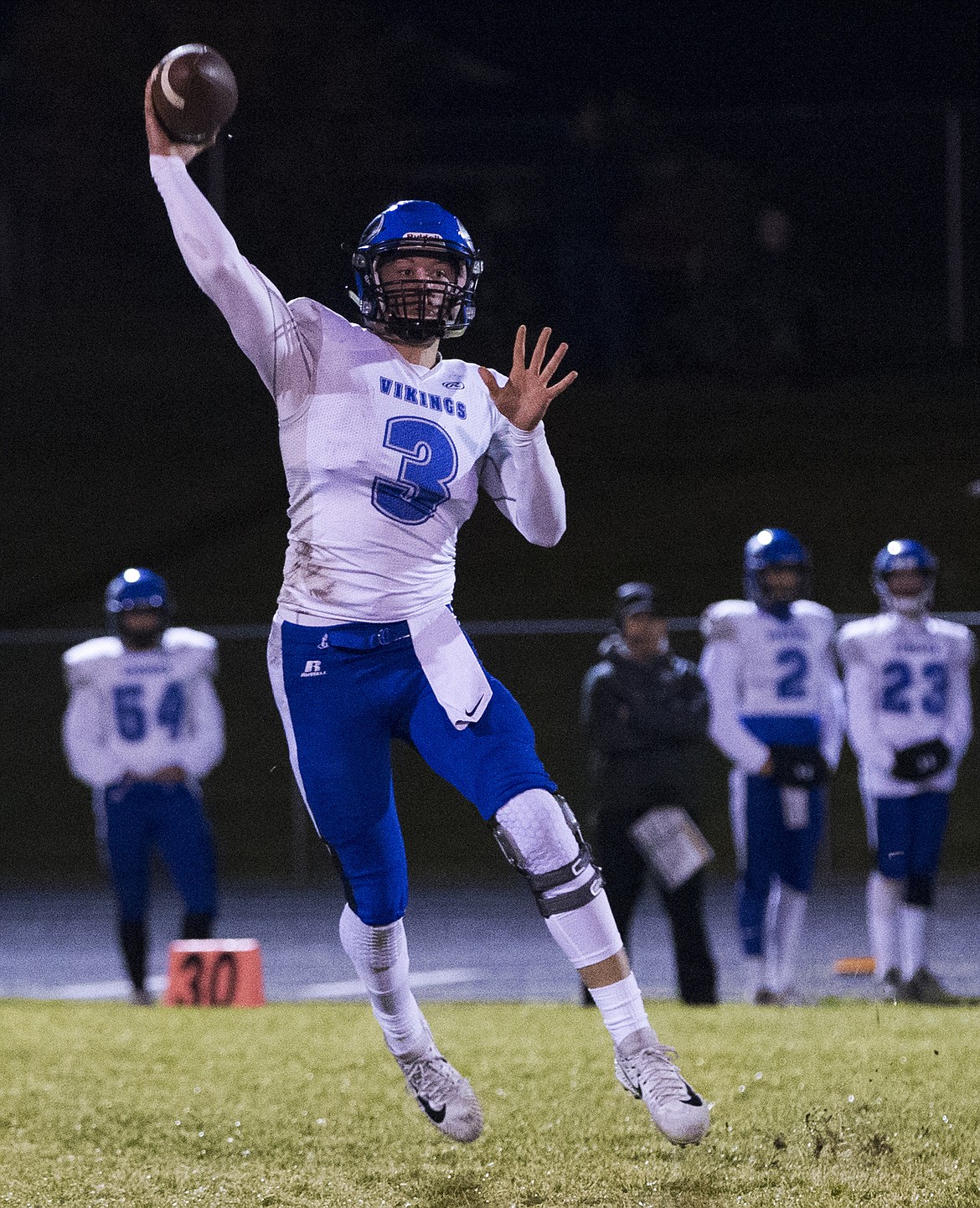 LOREN BENOIT/PressSenior Coeur d'Alene quarterback Cole Yankoff passes the ball to a wide receiver during Friday night's game against Lake City.