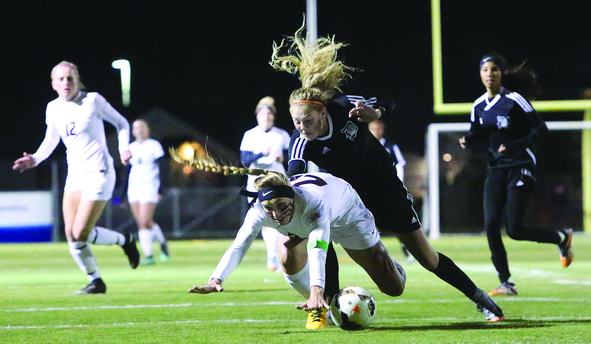 Connor Vanderweyst/Columbia Basin Herald
Moses Lake forward Abby Rathbun is tripped up by a Davis defender Tuesday at Lions Field.