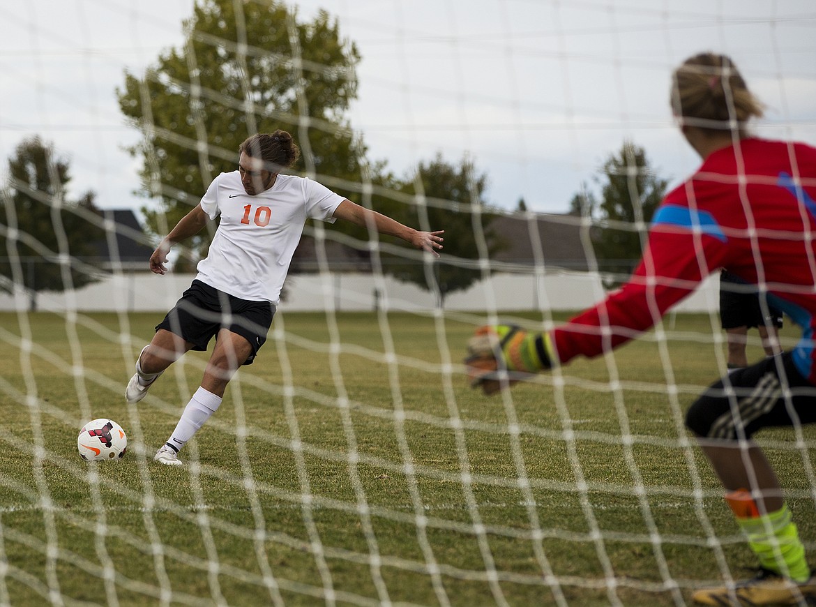 LOREN BENOIT/Press
Post Falls forward Diego Esquivel kicks the ball towards Coeur d&#146;Alene&#146;s goal during the 5A Region 1 Championship game on Wednesday at Post Falls High School. The Trojans defeated the Vikings 2-0.