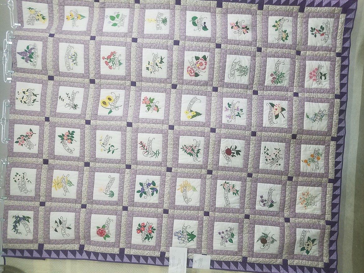 Photos by Tanna Yeoumans
The States Quilt, begun by the late Jeanie Karr and finished by her daughter and two others, has every state flower embroidered on it with their respective states.