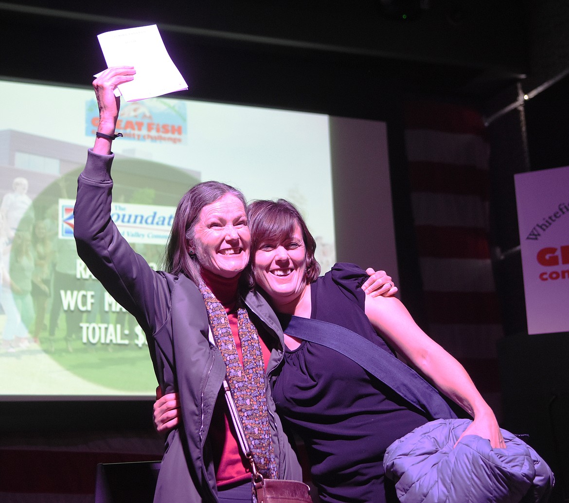 Colleen Unterreiner and Jill Seigmund of Flathead Valley Community College receive their matching grant at the Great Fish Community Challenge Awards on Thursday. (Daniel McKay/Whitefish Pilot)