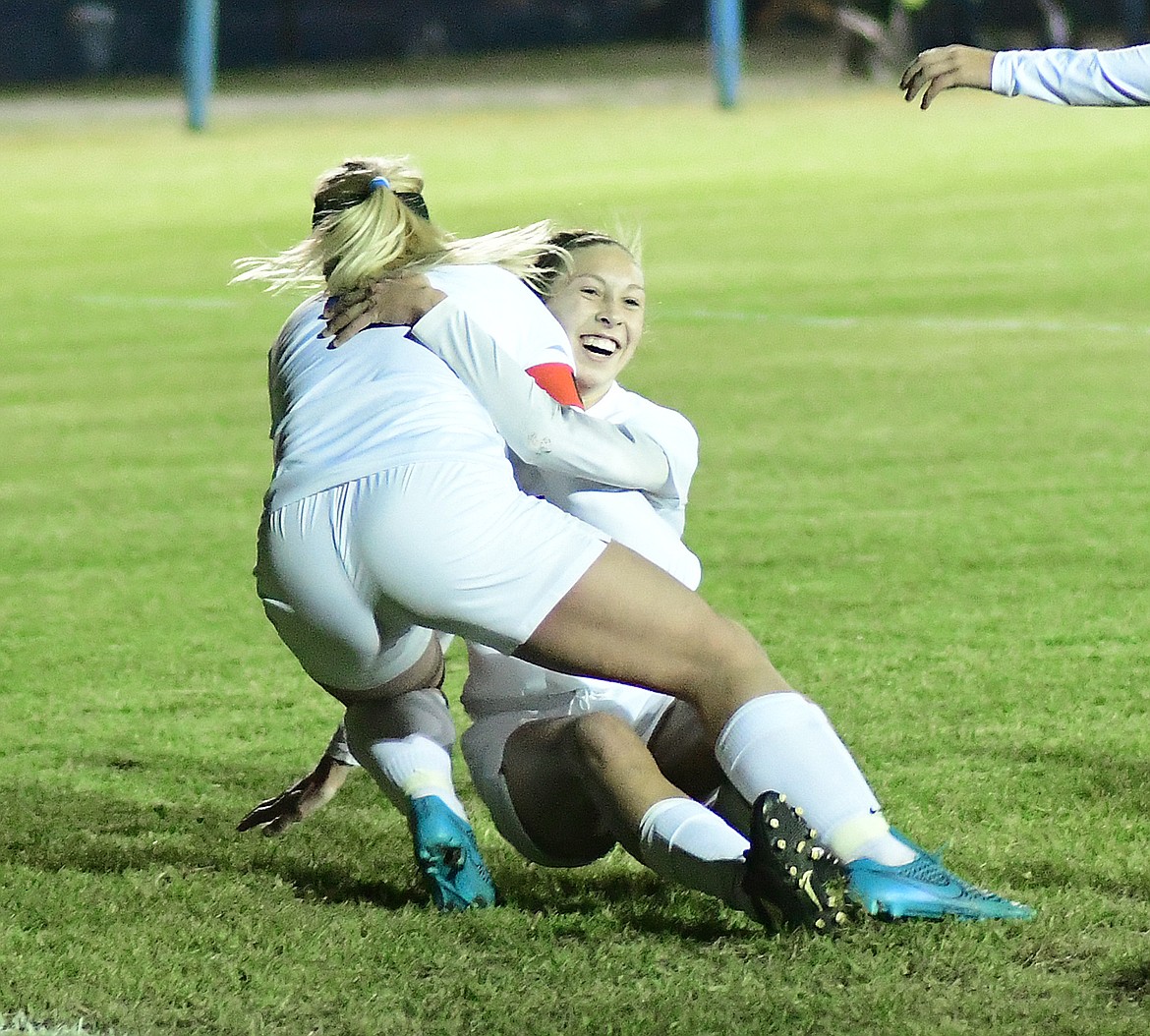 Josie Windauer gives Hannah Callendar a hug after a score in the first half.