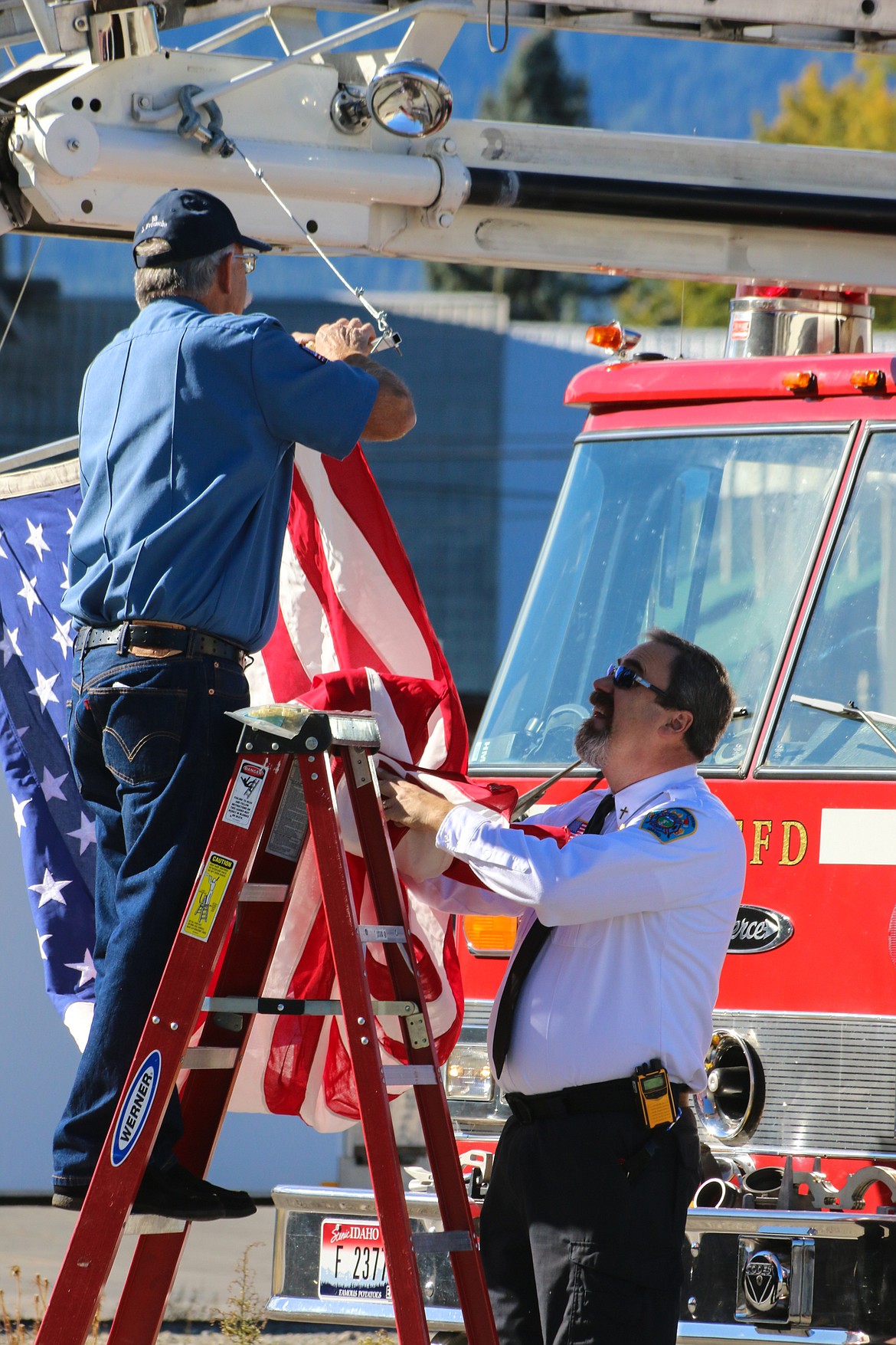 Photo by Mandi Bateman
Respectfully affixing the American Flag to Bonners Ferry Department Ladder 1.