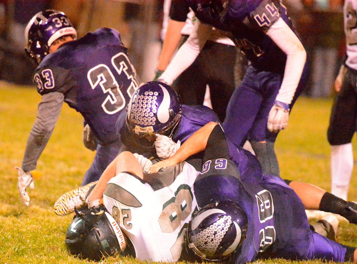 CHARLO DEFENSIVE Lineman Brock Tomlin and the Vikings' defense swarms to the ball carrier during the Charlo-Flint Creek game Friday night at Charlo High School. The Vikings 46-28 loss prevents Charlo from claiming home field advantage in the Class C, 8-man playoffs. (Jason Blasco/Lake County Leader)