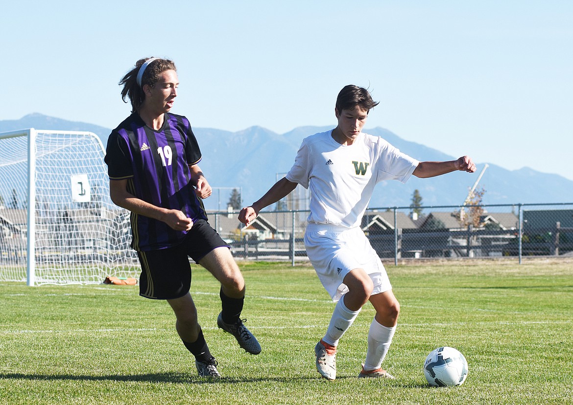 Joshua Gunderson gets past a Polson defender Thursday at Smith Fields. (Daniel McKay/Whitefish Pilot)