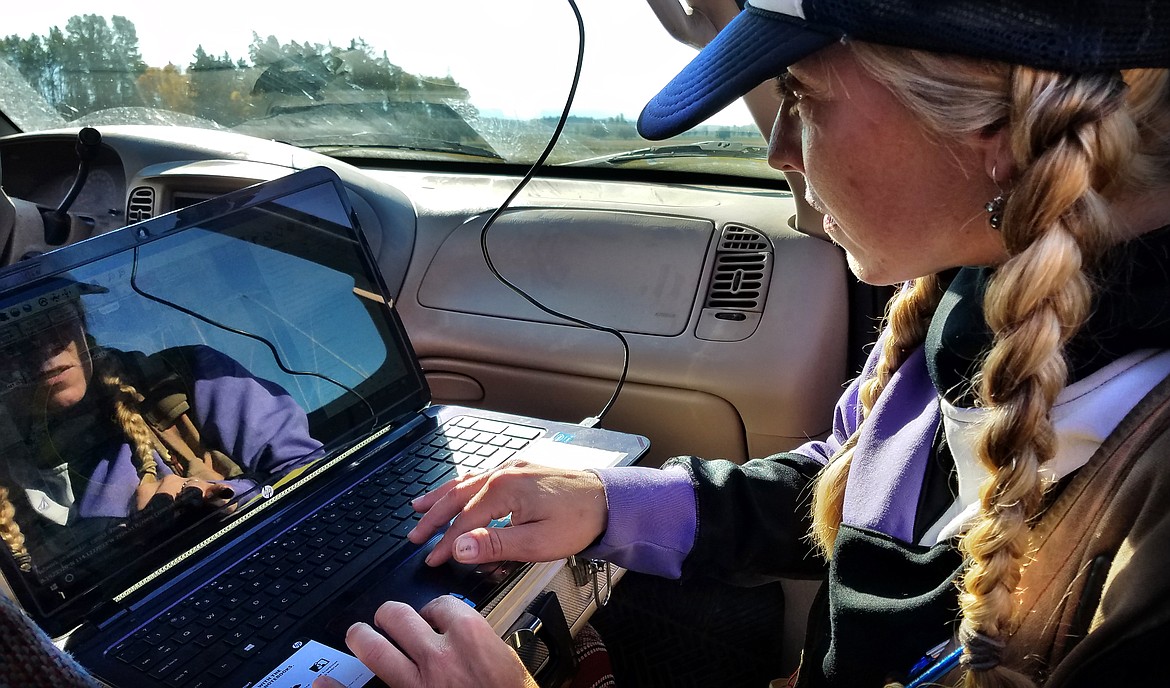 Carstens Surveying drone operator Carrie Fahlgren-Prewett monitors the flight of a drone near Creston earlier this month. (Jeremy Weber/Lake County Leader)