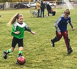 St. Regis Shylah Dalka kicks the ball past a Superior player during the last regular game of the U13 season. Tournaments will be in Plains this weekend. (Photo by Art Drobny).