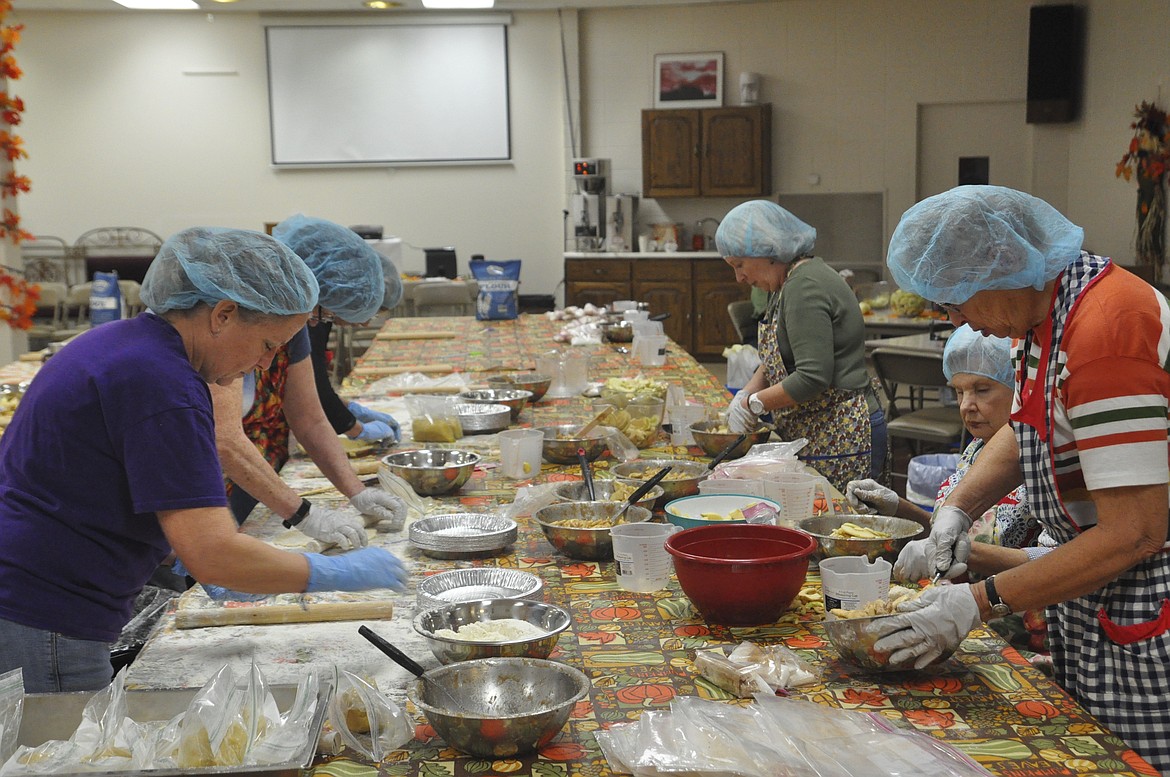 Twenty volunteers assembled apple pies Saturday at Immaculate Conception Catholic Church in Polson for the Fall Apple Fest. (Ashley Fox/Lake County Leader)